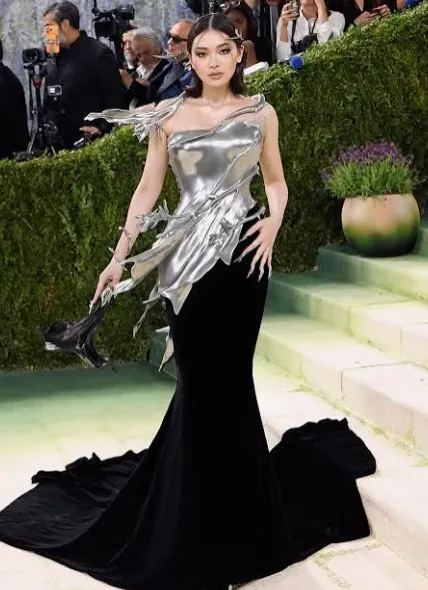 Silver sculptural top paired with a black evening skirt